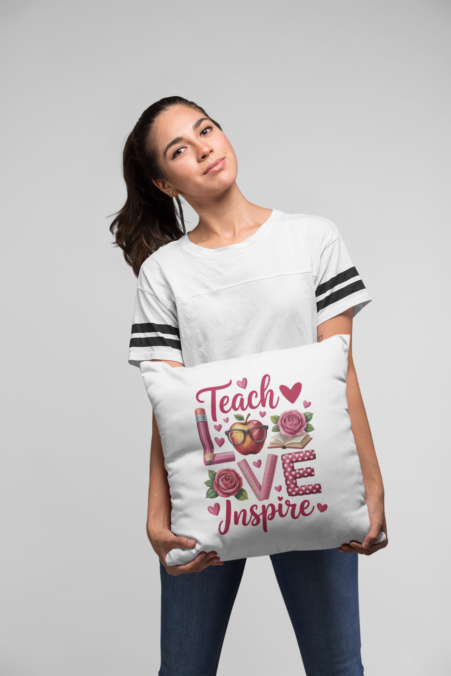 Woman holding a decorative pillow with a graphic design