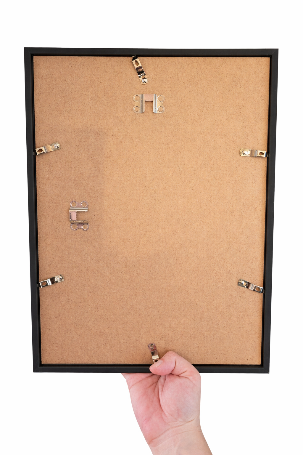 Hand holding a black picture frame with nails on a white background