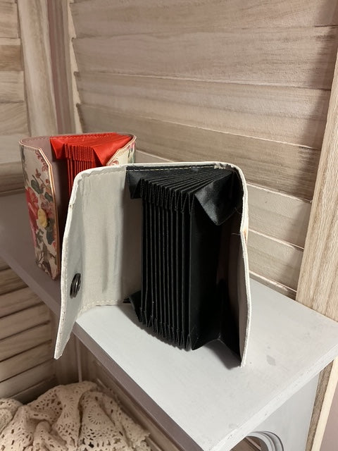Open book with a black interior on a wooden surface
