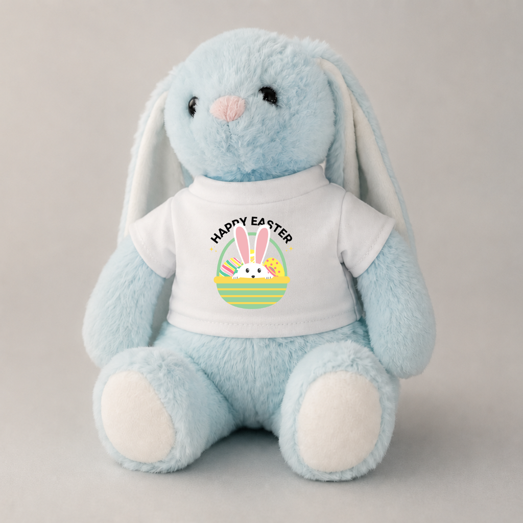 A light blue plush bunny toy wearing a white T-shirt with a colorful Easter graphic and the words 'HAPPY EASTER' on the front, photographed against a plain light gray background.