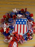 Decorative wreath with American flag design on a wooden surface