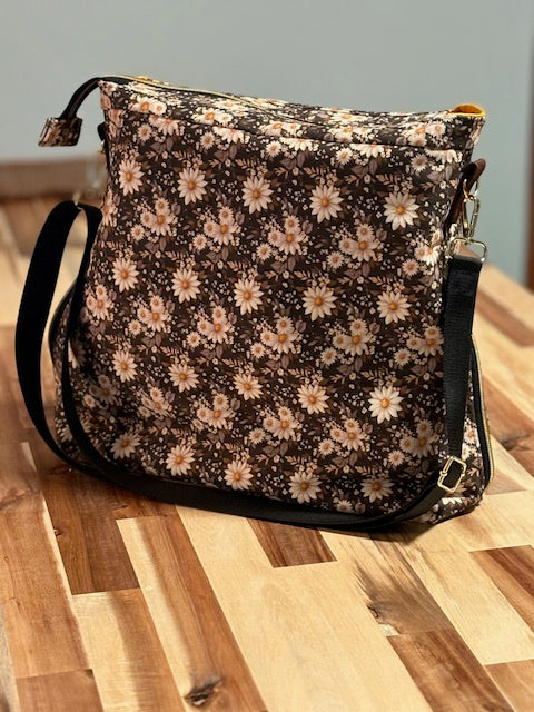 Floral-patterned handbag on a wooden surface
