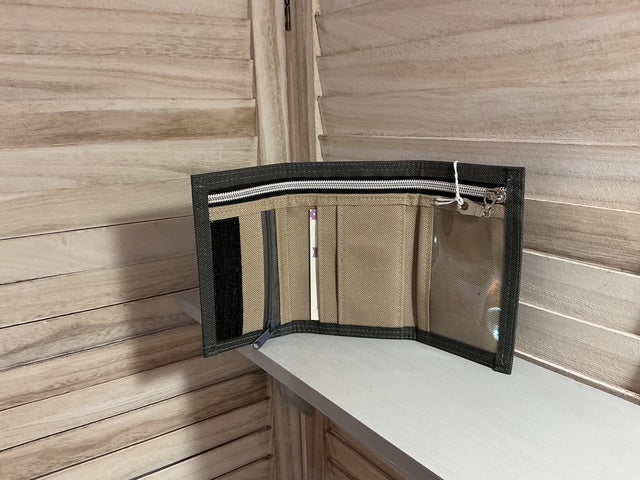 Clear plastic bag with black zipper on a wooden surface