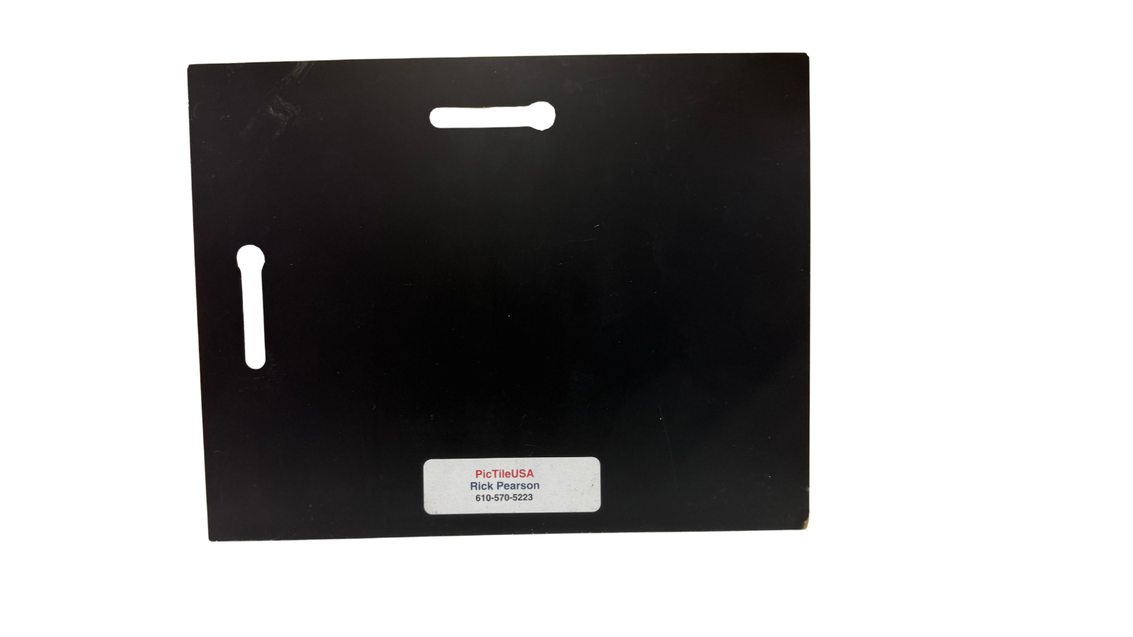 Black rectangular product with a label on a white background