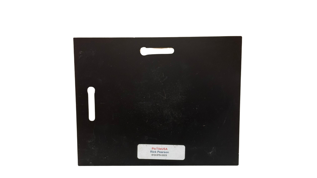 Black rectangular object with cutouts on a white background