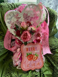 Valentine's Day card with decorative elements on a green fabric background