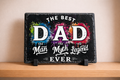 Decorative sign with 'The Best Dad, The Man, The Myth, Legend Ever' text on a black background with colorful splashes.
