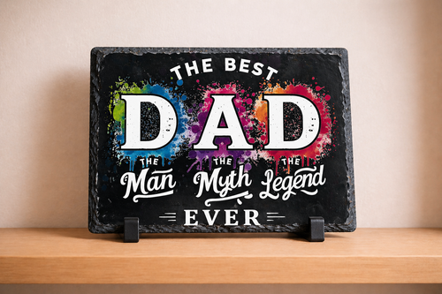 Decorative sign with 'The Best Dad, The Man, The Myth, Legend Ever' text on a black background with colorful splashes.