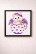Framed cross-stitch art of a cat with angel wings in a teacup on a white background