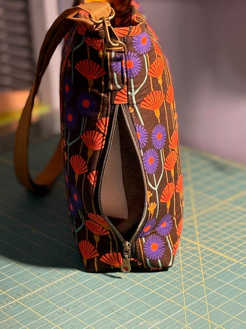 Small bag with floral pattern on a green cutting mat