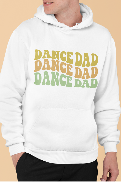 White hoodie with 'DANCE DAD' text in multiple colors on a beige background