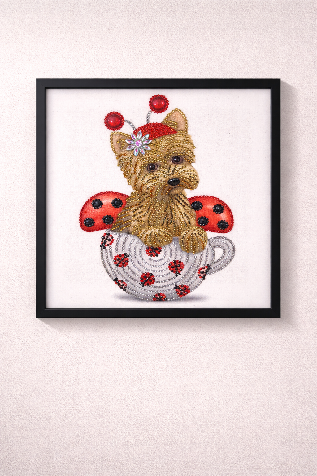 Framed artwork of a dog with ladybug decorations on a white background