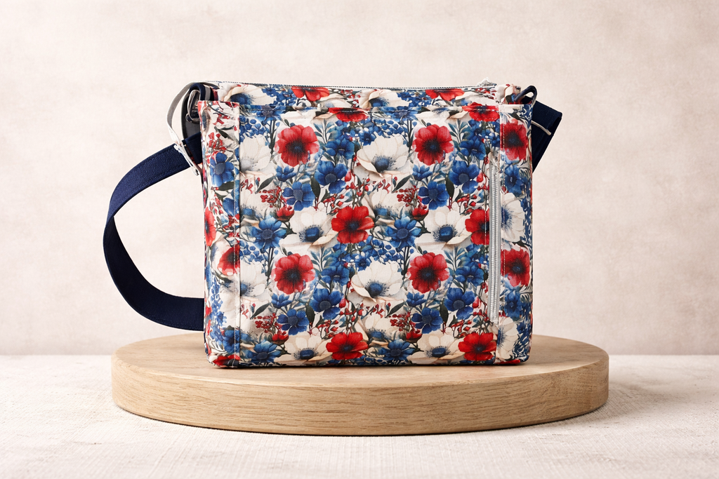 Floral patterned bag on a wooden platform with a neutral background