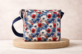 Floral patterned bag on a wooden platform with a neutral background