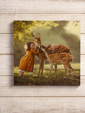 Canvas print of a girl in an orange dress interacting with two deer in a natural setting.