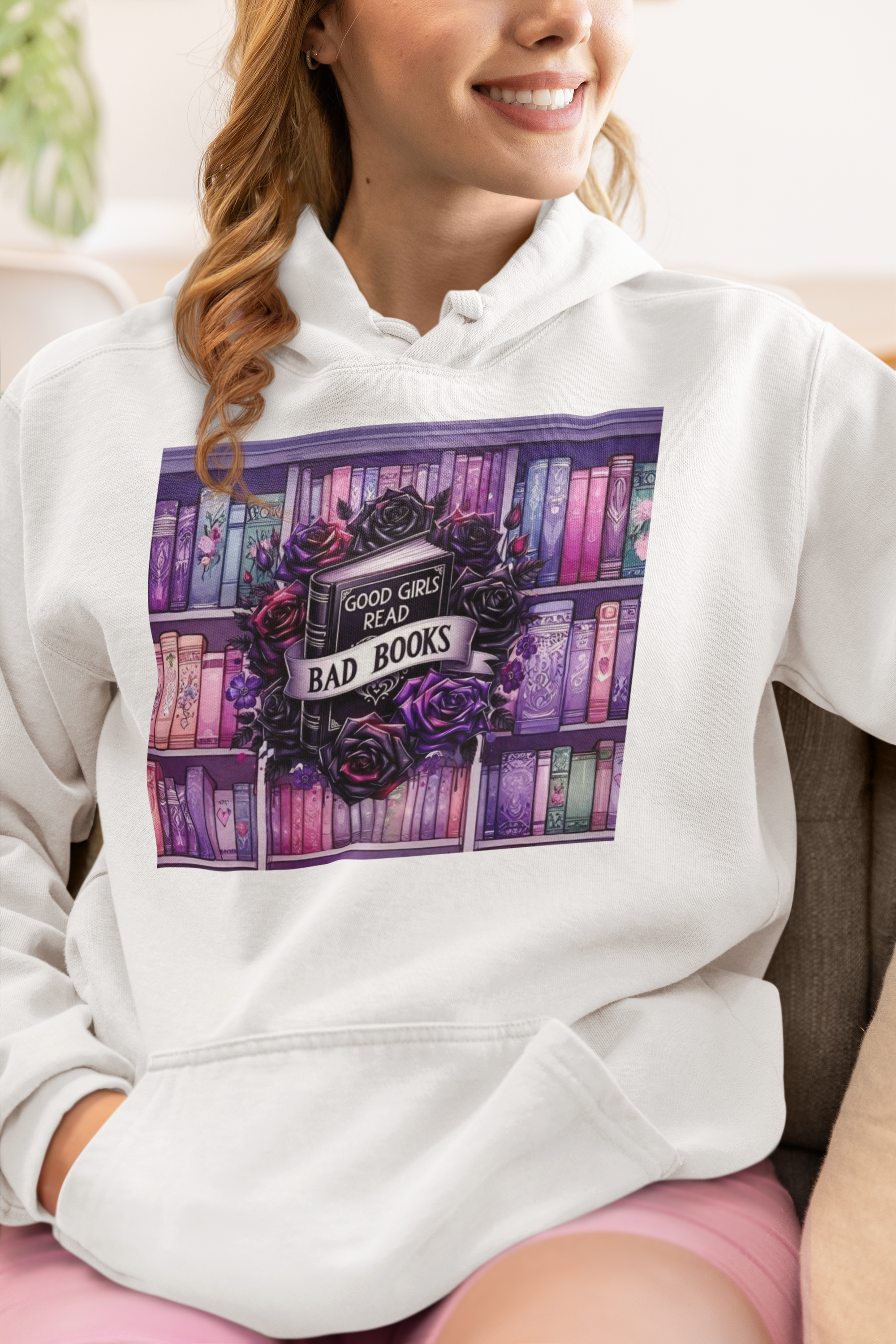 Hoodie with graphic of black book surrounded by black roses that says "Good Girls Read Bad Books"