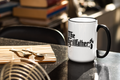White mug with black handle and 'The Grillfather' design on a kitchen counter.