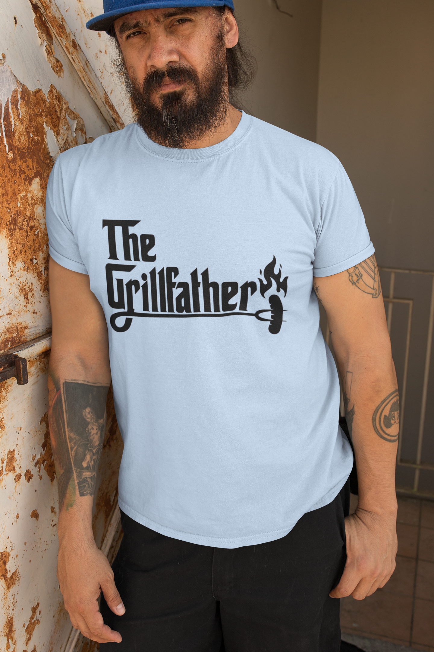 Man wearing a light blue t-shirt with 'The Grillfather' graphic design.
