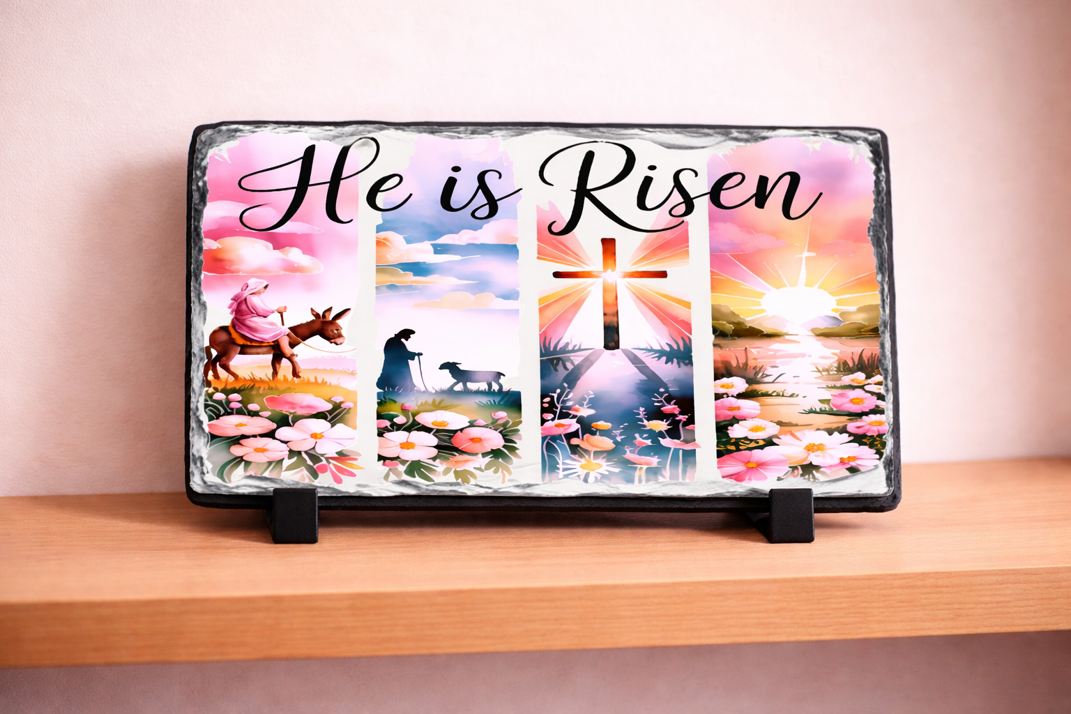 Decorative slate with 'He is Risen' text and Easter-themed illustrations on a wooden shelf.
