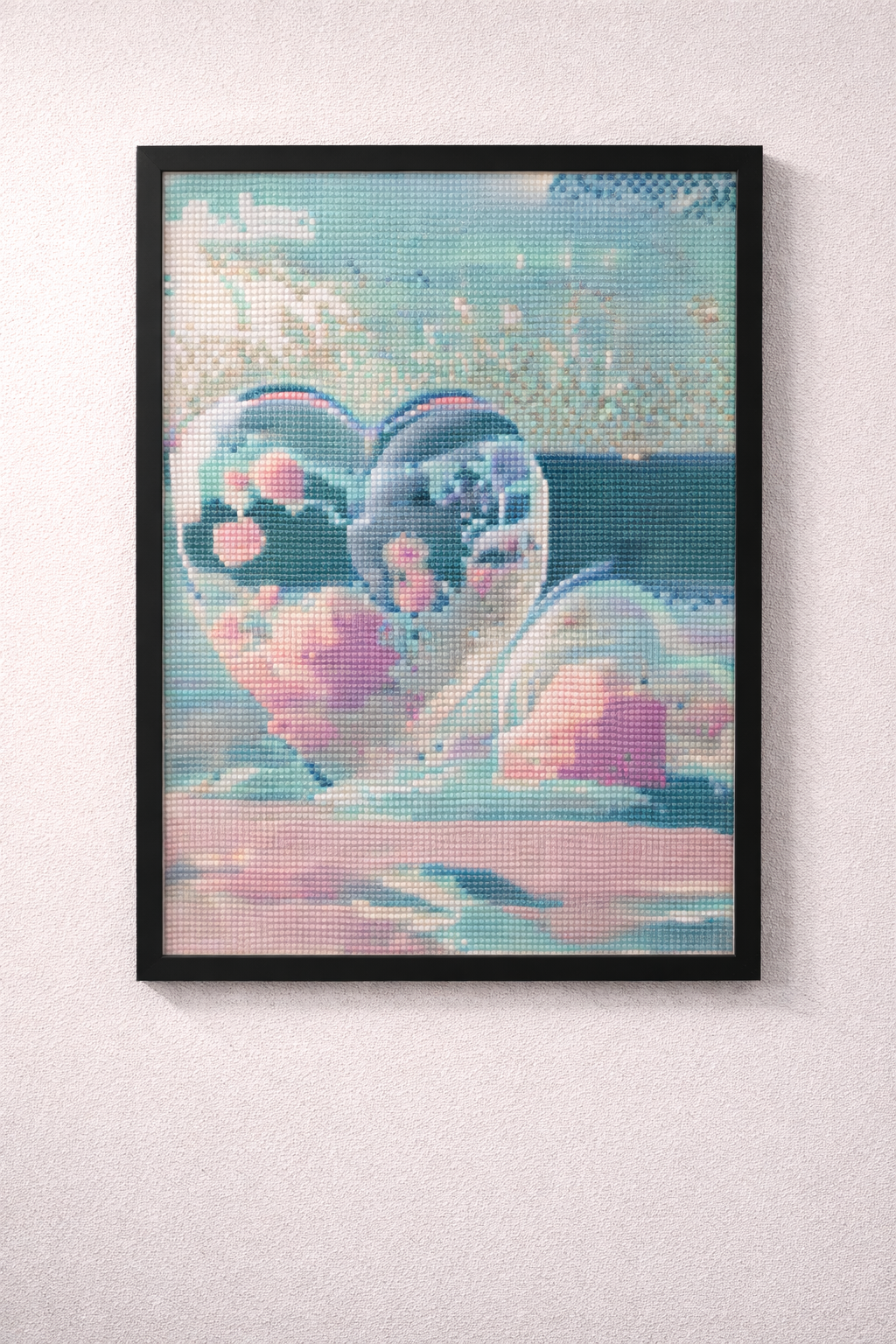 Framed artwork of a heart-shaped object with colorful design on a white wall