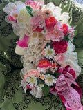 Decorative floral arrangement with ribbons on a patterned background
