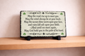 Decorative plaque with inspirational quote on a wooden shelf