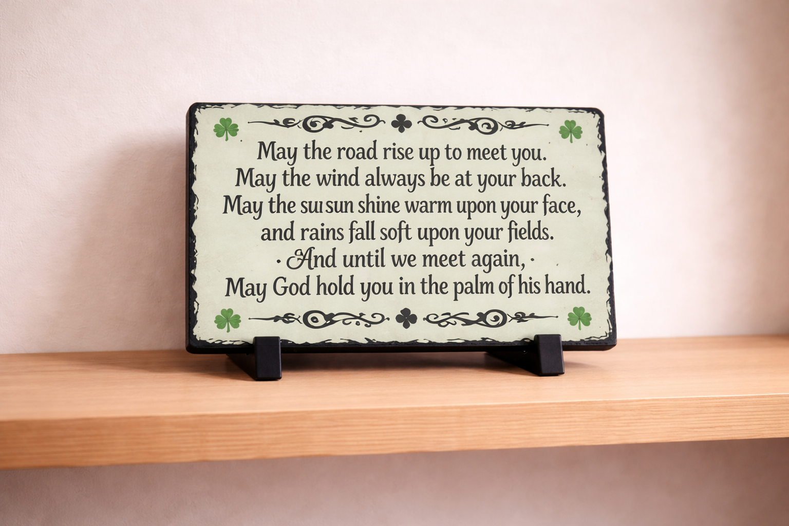 Decorative plaque with inspirational quote on a wooden shelf
