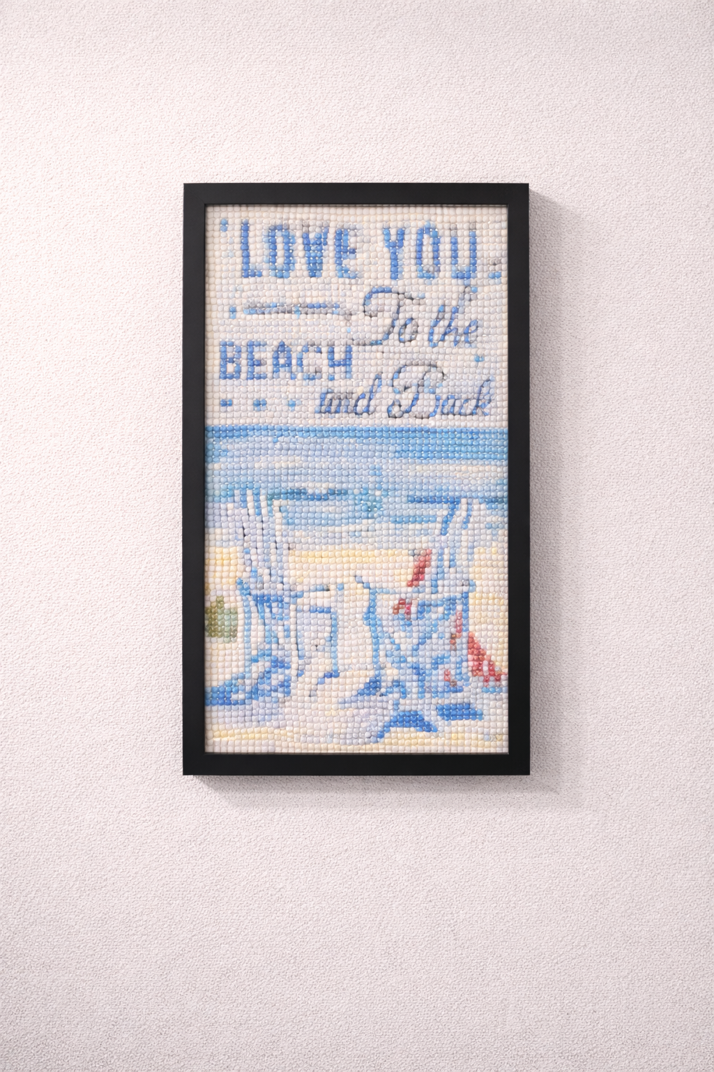 Framed artwork with 'Love you to the beach and back' text and beach scene.