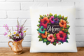Decorative pillow with floral design and 'I Love You Mom' text, placed on a wooden surface with a white brick wall background.
