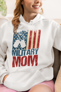 Person wearing a white hoodie with 'Military Mom' design featuring an American flag.