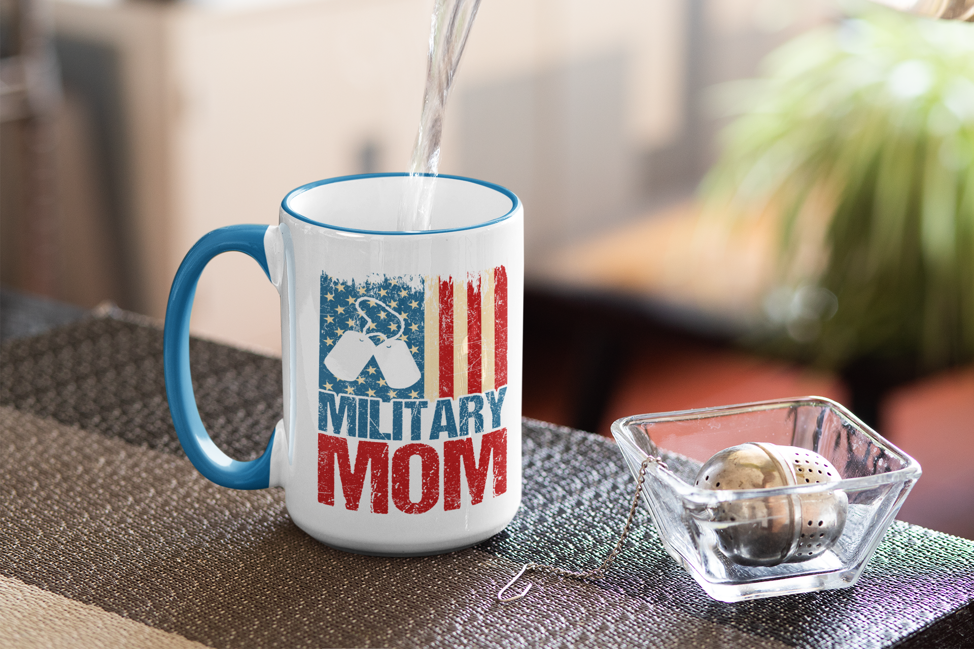 Mug with 'Military Mom' design being filled with liquid on a table.