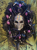 Decorative wreath with skull and candles on a patterned background