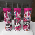 Three pink tumblers with skeleton design and text on a white surface.