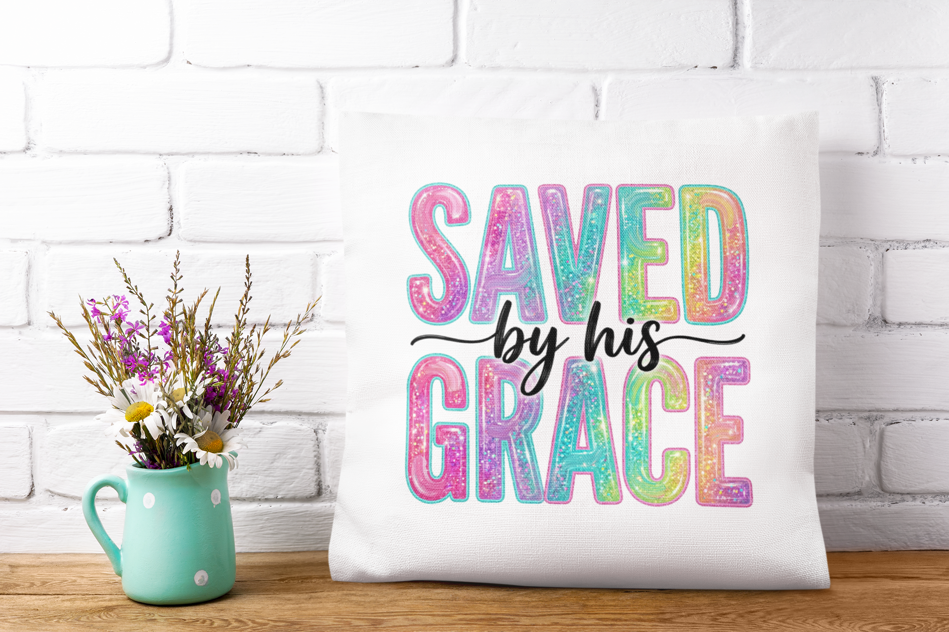 Decorative pillow with 'Saved by his Grace' text on a white brick wall background