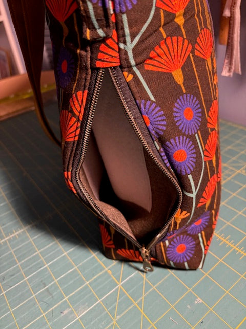 Fabric pouch with floral pattern on a cutting mat