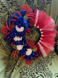 Decorative flower arrangement with red, blue, and white flowers on a patterned background
