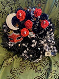 Decorative wreath with Halloween-themed elements on a green fabric background
