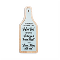 Wooden paddle with humorous text on a light blue background