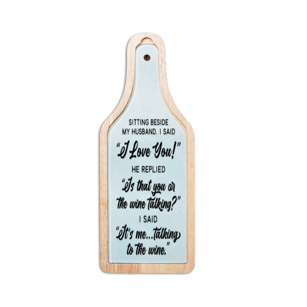 Wooden paddle with humorous text on a light blue background