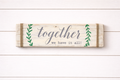 Wooden sign with 'together we have it all' text on a white wooden background