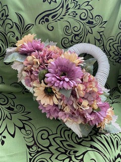 Decorative basket with flowers on a patterned fabric background